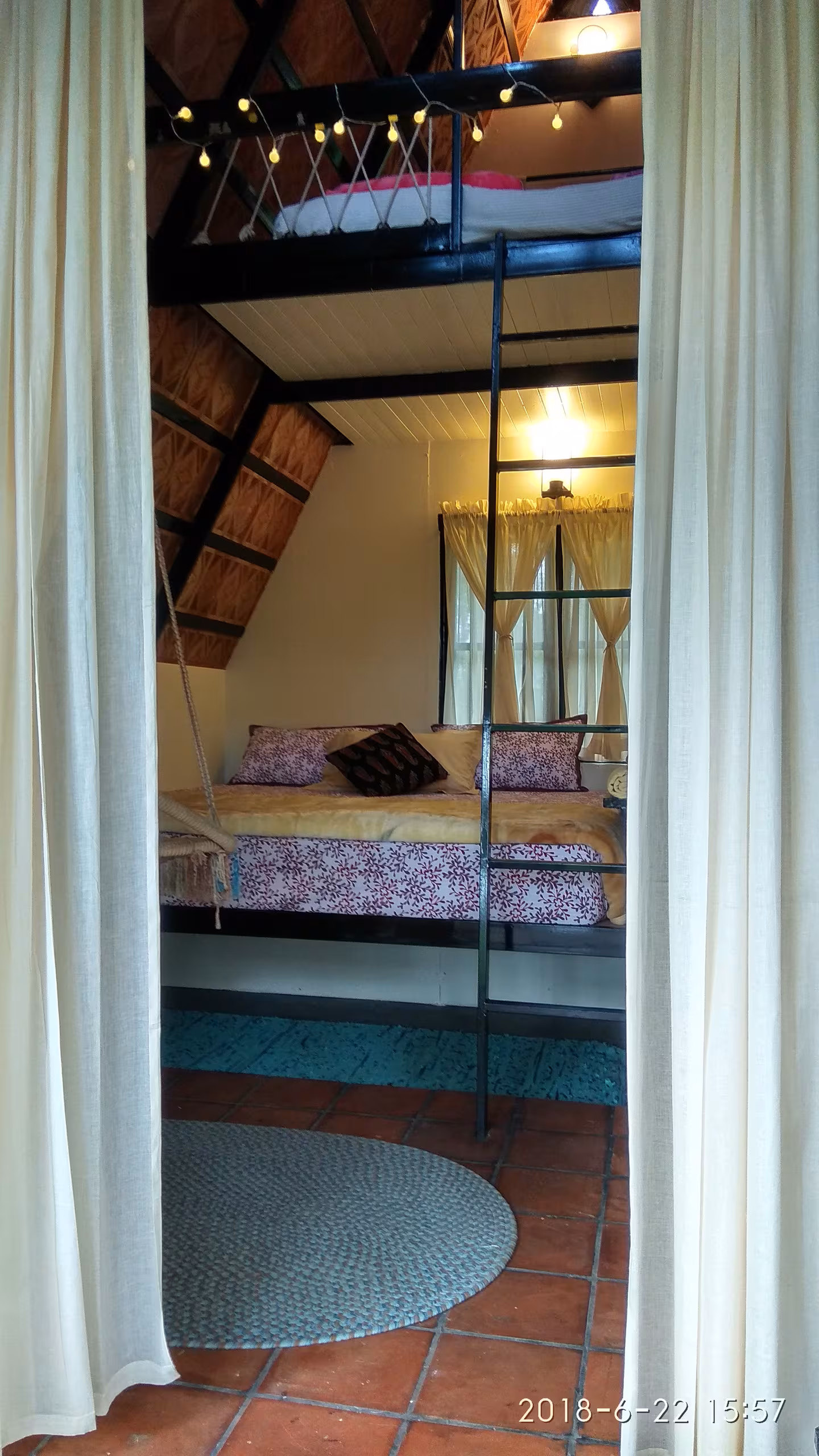 The bed in the Riverloft with early light coming through the window
